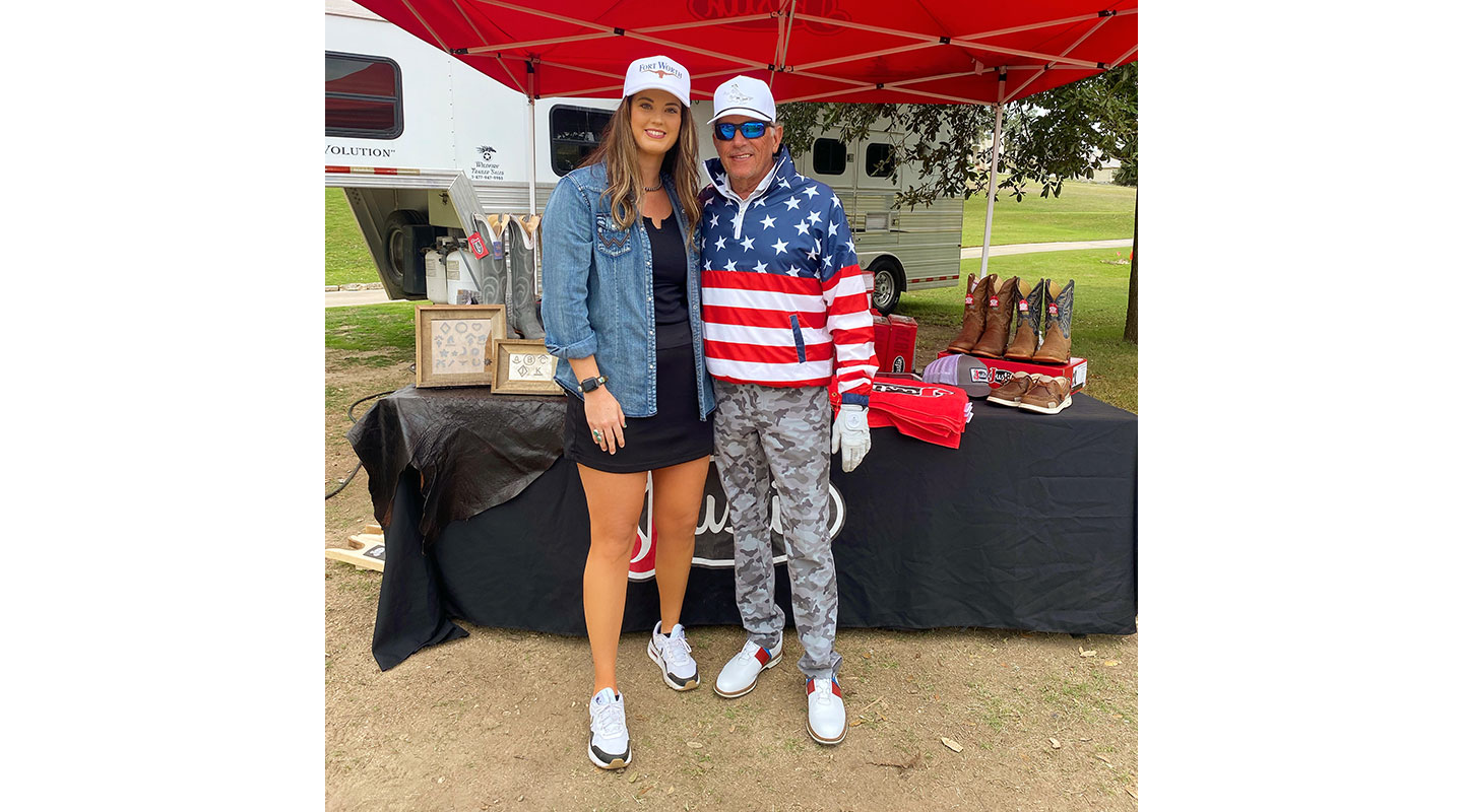 A woman, Shelbi Tidwell, with George Strait, in the sun at a golf tournament.